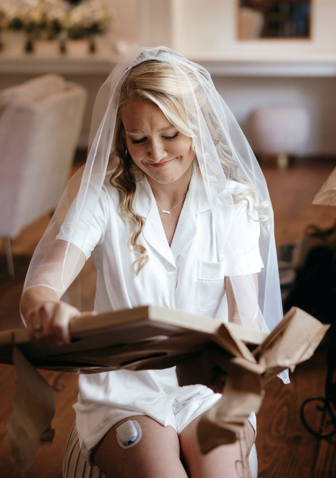 Bride opening gift on day of wedding